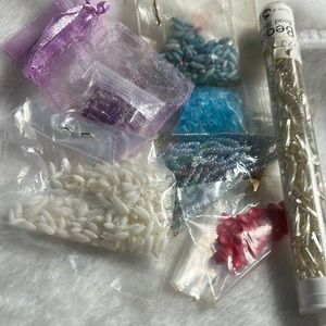 Seed beads- seven packages, purple, red blue, white, and silver.